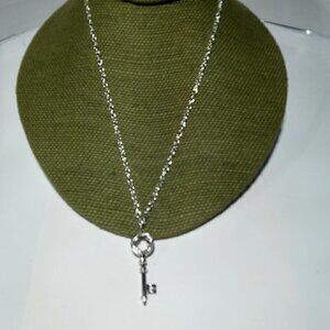 Women`s silver tone crystal key necklace.